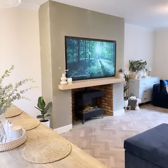 Living room media wall with TV, mantel shelf and fire recess