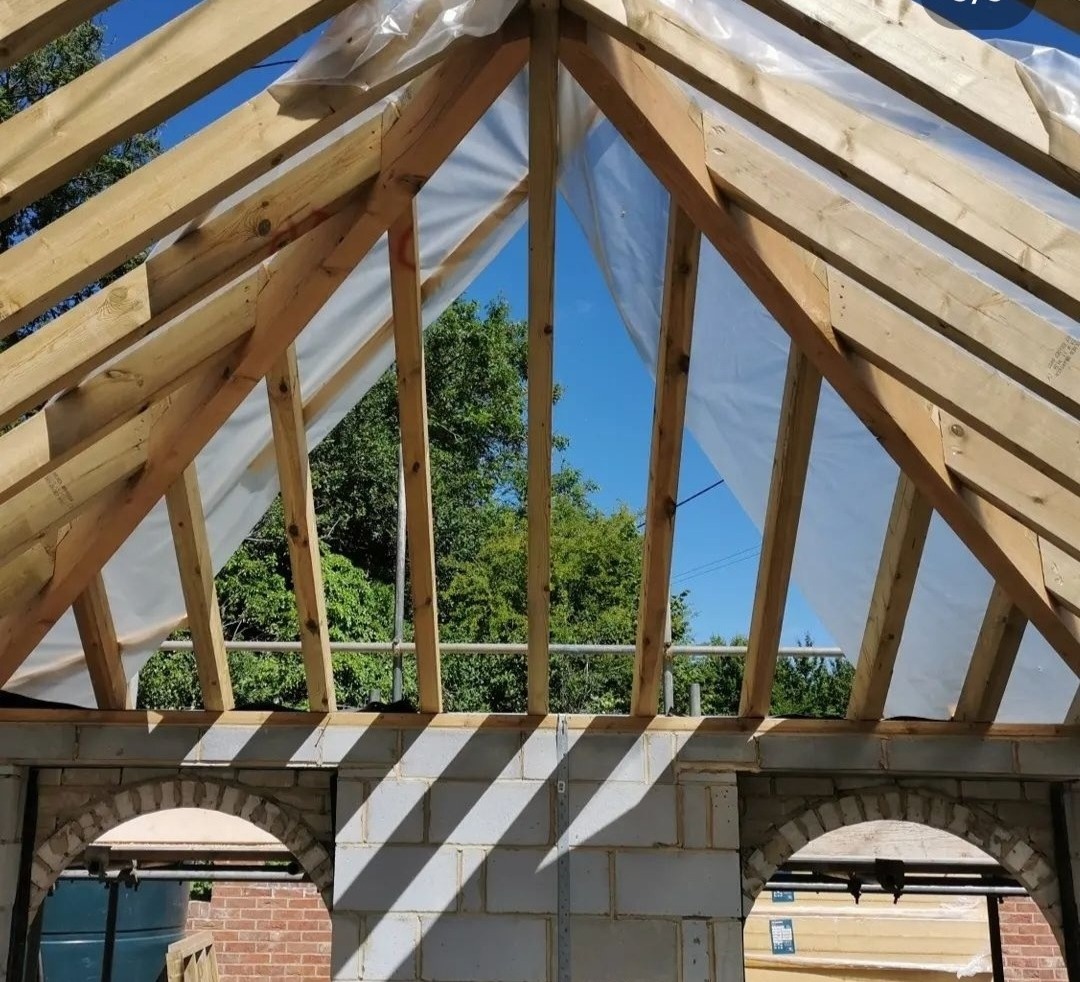 Roof timbers over a blockwork extension with arched openings