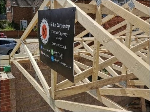 Roof trusses with the G & H Carpentry site board