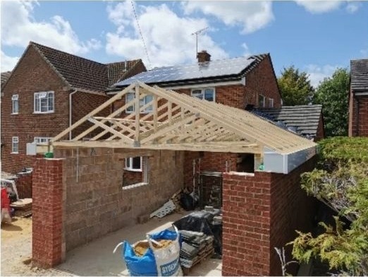 New roof trusses on a brick extension between houses