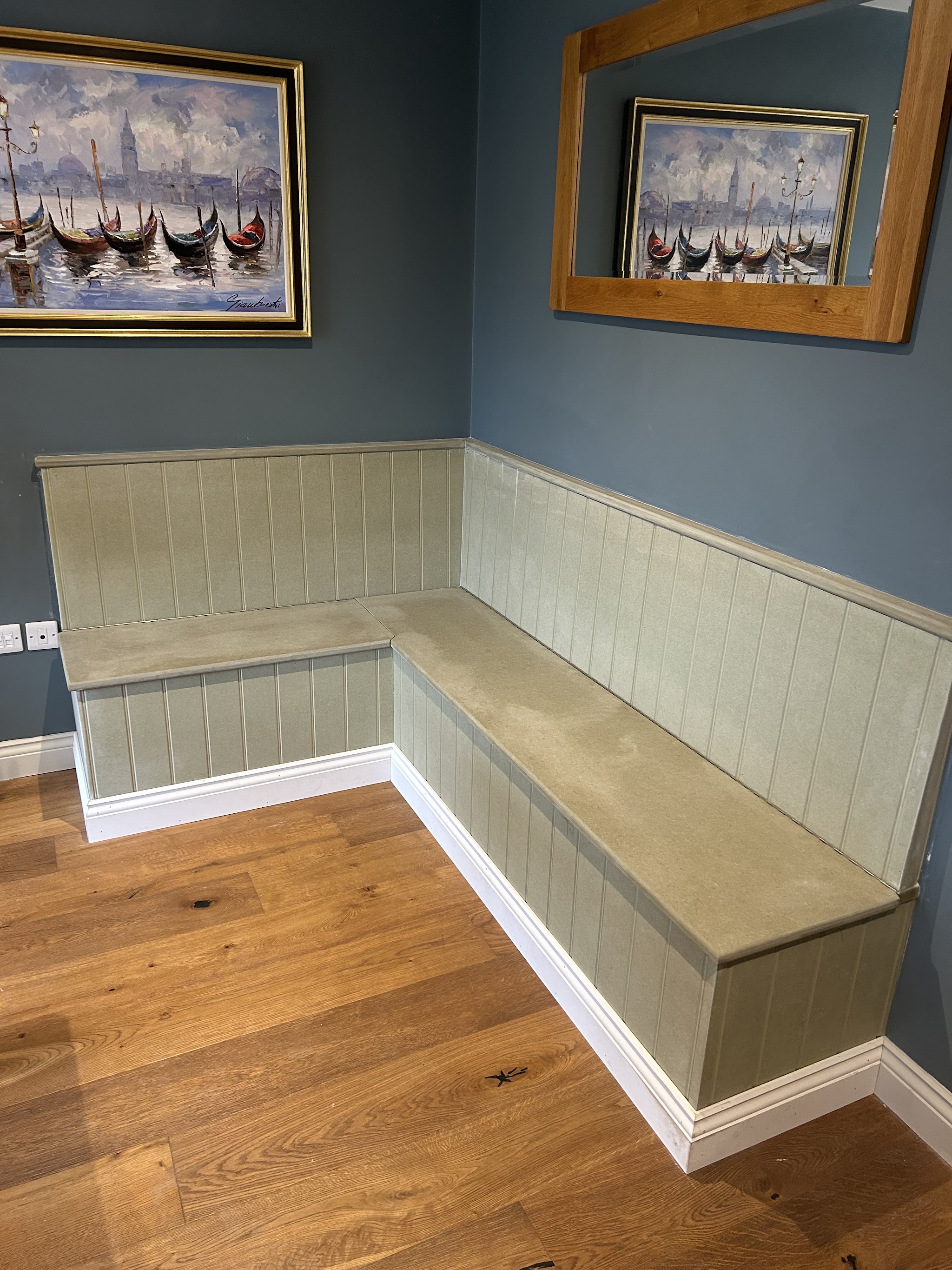 L-shaped panelled banquette seat with storage