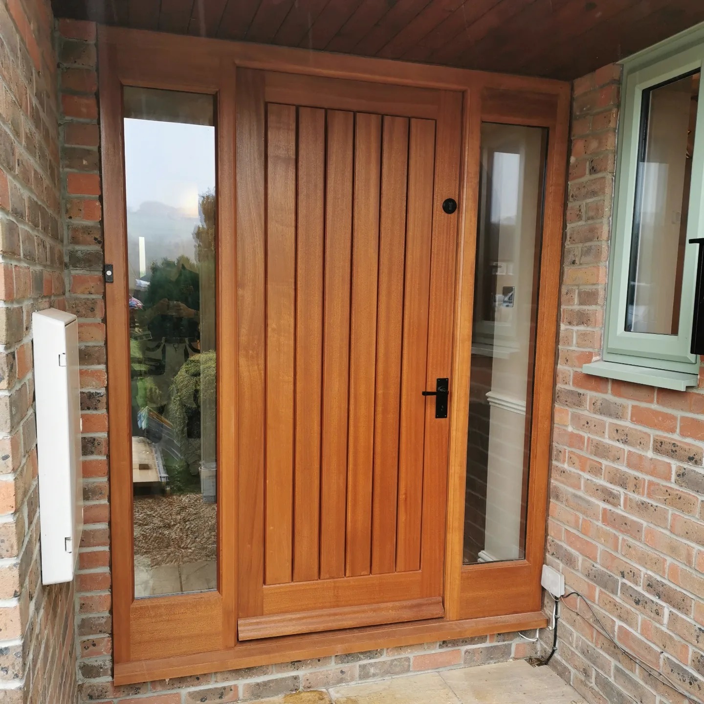 Oak front door and frame set into brickwork